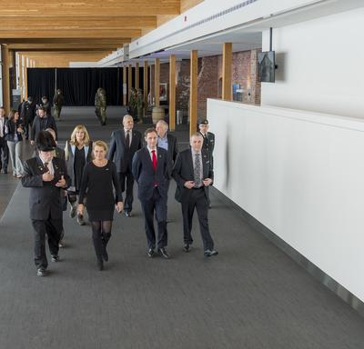 Governor General Julie Payette, accompanied by a group of about 10 people walk in the entrance hall of the Armoury of Les Voltigeurs de Québec.