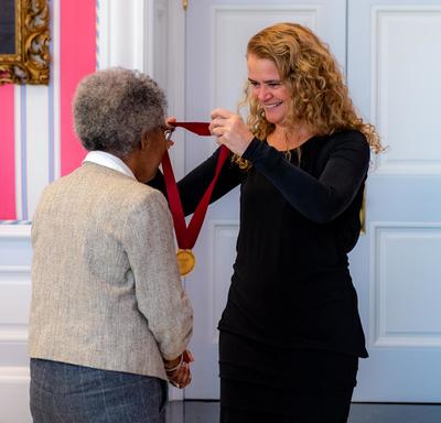 The Governor General gives a medal to Sylvia D. Hamilton.
