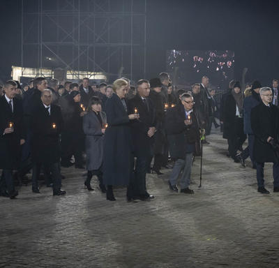 Survivors and world leaders walked with candles in their hands. 