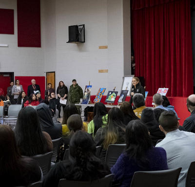 The Governor General delivers a presentation at a high school.