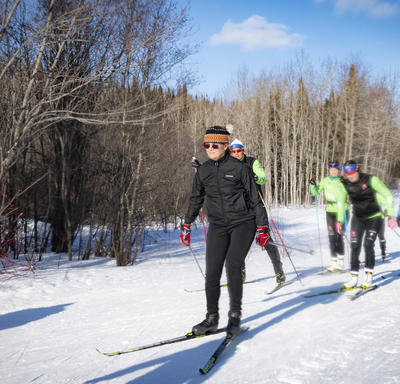 The Governor General cross country skis with competitive racers and youth.