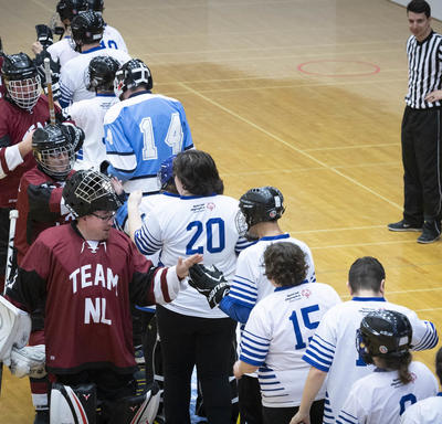 Two teams line up to shake hands after a hard-fought game. 