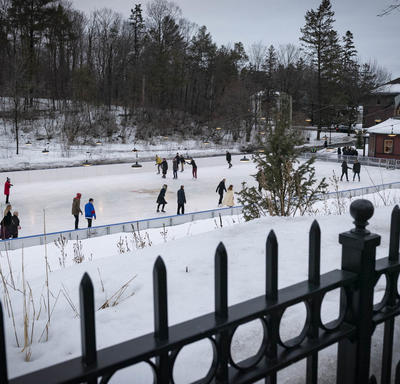 A photo of the Rideau Hall skating rink taken from above, bustling with skaters.