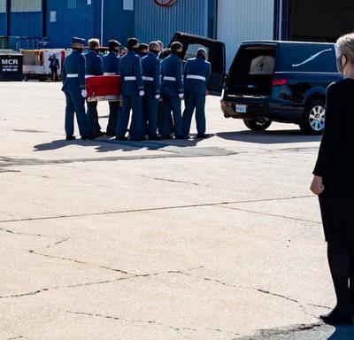 The Governor General and Commander-in-Chief of Canada stands as Captain Jennifer Casey’s coffin is placed in the hearse.