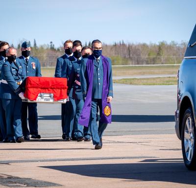  Captain Jennifer Casey’s coffin is carried by Canadian Armed Forces members to the hearse. Leading the way is the chaplain. 