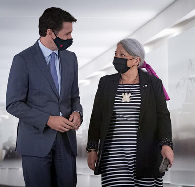 1.	Prime Minister Justin Trudeau and Governor General Designate Mary May Simon look at each other as they walk side-by-side down a hall..