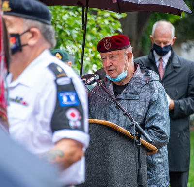 A veteran speaks at a podium.