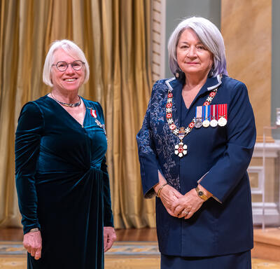 Mary Ruth Brooks is standing next to the Governor General.