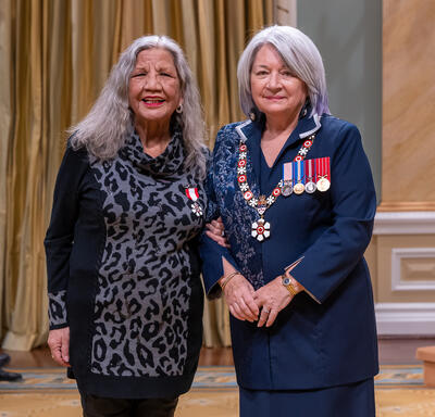 Gail Cyr is standing next to the Governor General.