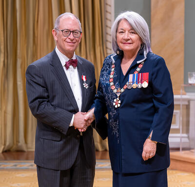 Rabbi Baruch Frydman-Kohl is standing next to the Governor General.