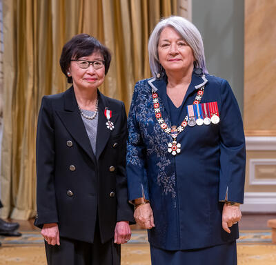 Janice Fukakusa is standing next to the Governor General.