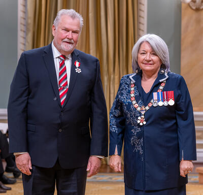 David Grimes is standing next to the Governor General.