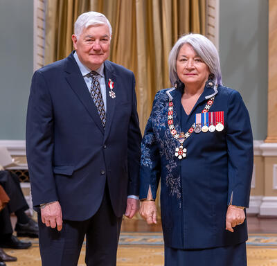 Stanley Hamilton is standing next to the Governor General.