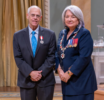 Peter Daniel Alexander Jacobs is standing next to the Governor General.