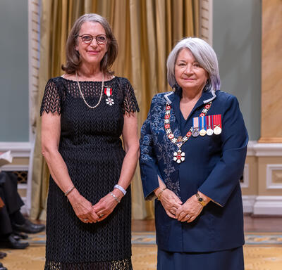 Cathy Levy is standing next to the Governor General.