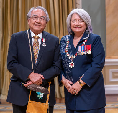 Harvey Andrew McCue (Waubageshig) is standing next to the Governor General.