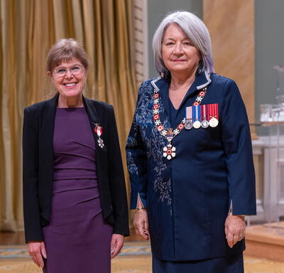 Lynn McIntyre is standing next to the Governor General.
