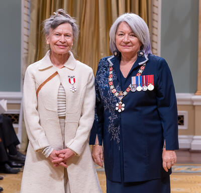 Robin Poitras is standing next to the Governor General.