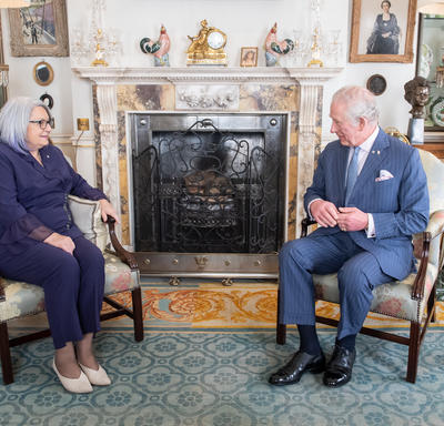 His Royal Highness The Prince of Wales and Governor General Mary Simon are sitting across from each other in a room at Clarence House. 