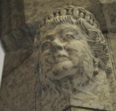 Bust of The Queen carved in stone on the side of a pillar. 