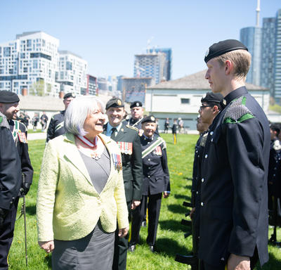The Governor General is greeting a member of the Queen’s York Rangers.
