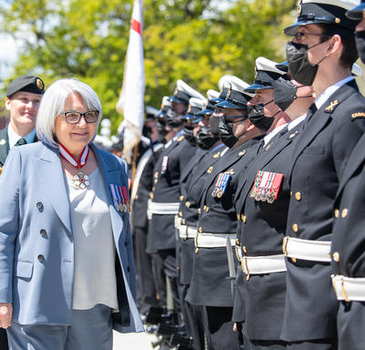 Governor General Simon is inspecting a guard of honour.