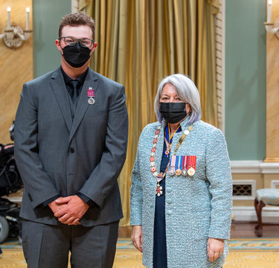 Connor Stanle standing next to the governor general.