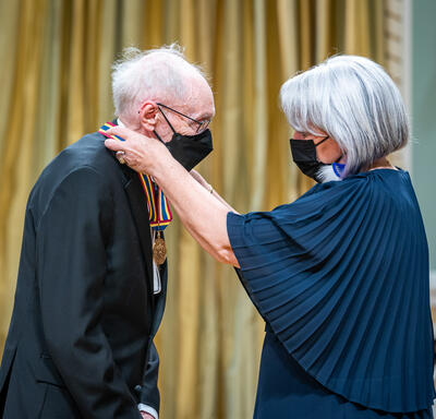 Fernand Dansereau, film and television screenwriter, director and producer, receiving an award from the Governor General.