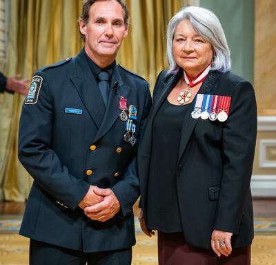 Bravery recipient Constable Paul Morin is standing next to the Governor General.