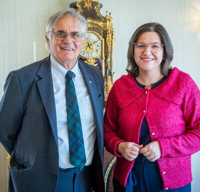 Mr. Fraser is standing next to Mrs. Eliza Reid, the First Lady of Iceland.
