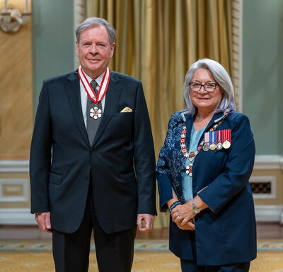 Raymond A. J. Chrétien is standing next to the Governor General.