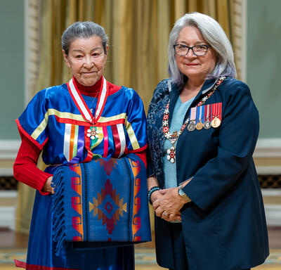 Elder Doreen Spence is standing next to the Governor General.