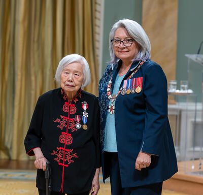Lily Siewsan Chow is standing next to the Governor General.