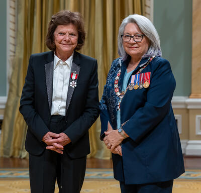Liliane Colpron is standing next to the Governor General.
