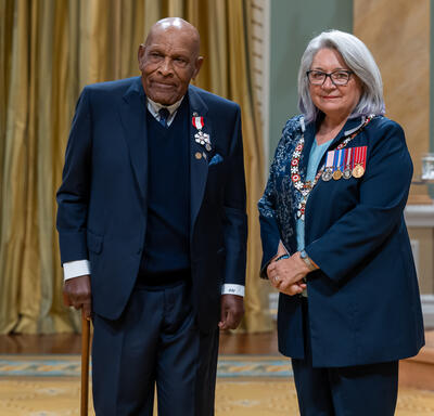 B. Denham Jolly is standing next to the Governor General.