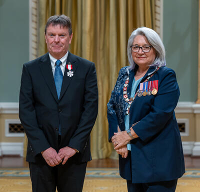Michel Doucet is standing next to the Governor General.