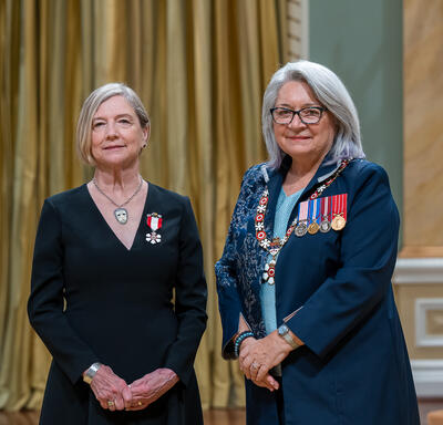 Patricia M. Feheley is standing next to the Governor General.