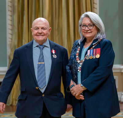 Charles Edgar Fipke is standing next to the Governor General.
