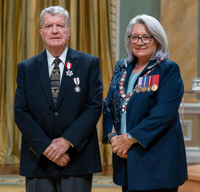 Gary Gullickson is standing next to the Governor General.