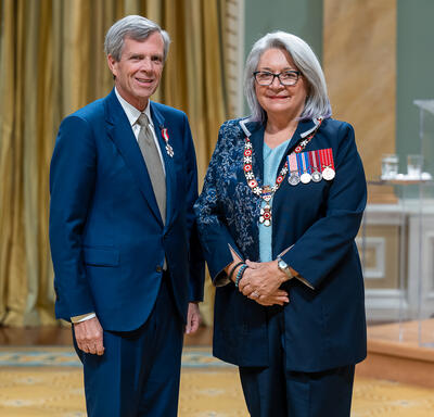 Jon E. Love is standing next to the Governor General.
