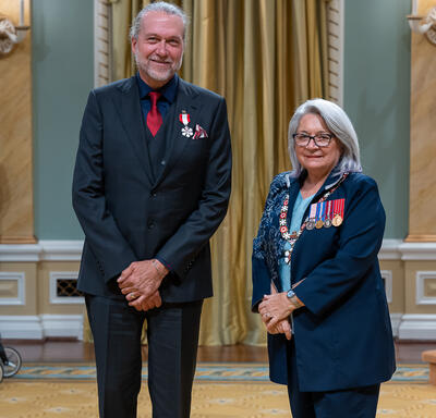 Michael Dixon Smith is standing next to the Governor General.