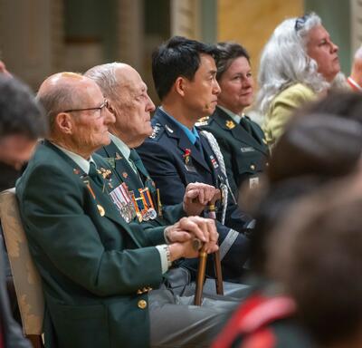 An audience of people are seated in rows.