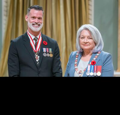 Mark Roger Tewksbury is standing next to the Governor General.