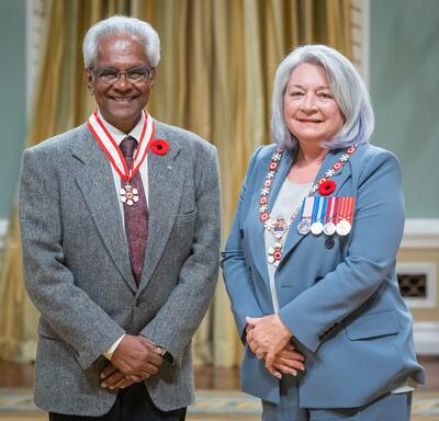 Neil Devindra Bissoondath is standing next to the Governor General.