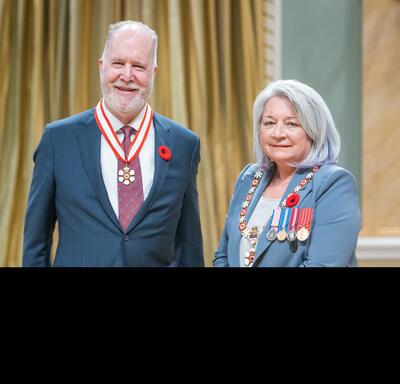 Graham Fraser is standing next to the Governor General.