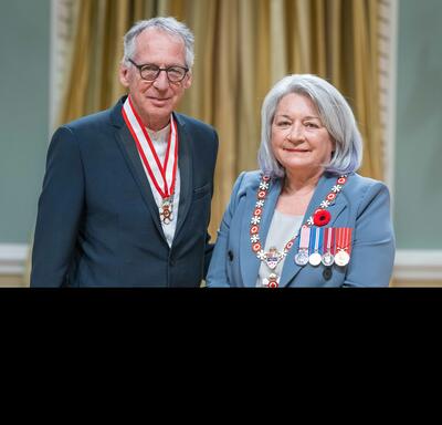 Gilles Ste-Croix is standing next to the Governor General.