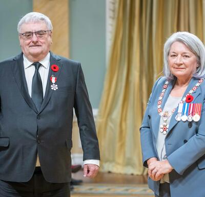 Maurice Brisson is standing next to the Governor General.