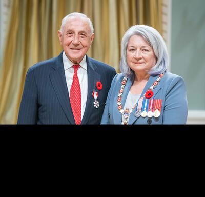 Morris Goodman is standing next to the Governor General.