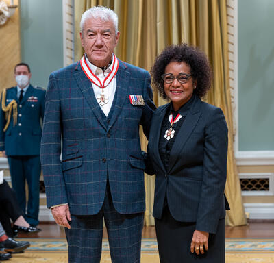 Tom Jackson is standing next to The Right Honourable Michaëlle Jean.