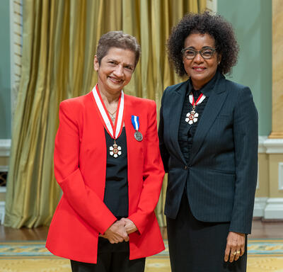 Alice Benjamin is standing next to The Right Honourable Michaëlle Jean.